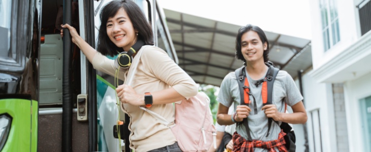 Smiling shuttle bus riders attending an event